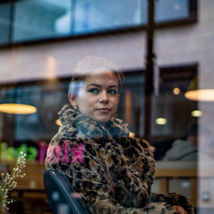 Avery Chen, Lead Design Curator at OakMeadowLab, reviewing corporate floral arrangements